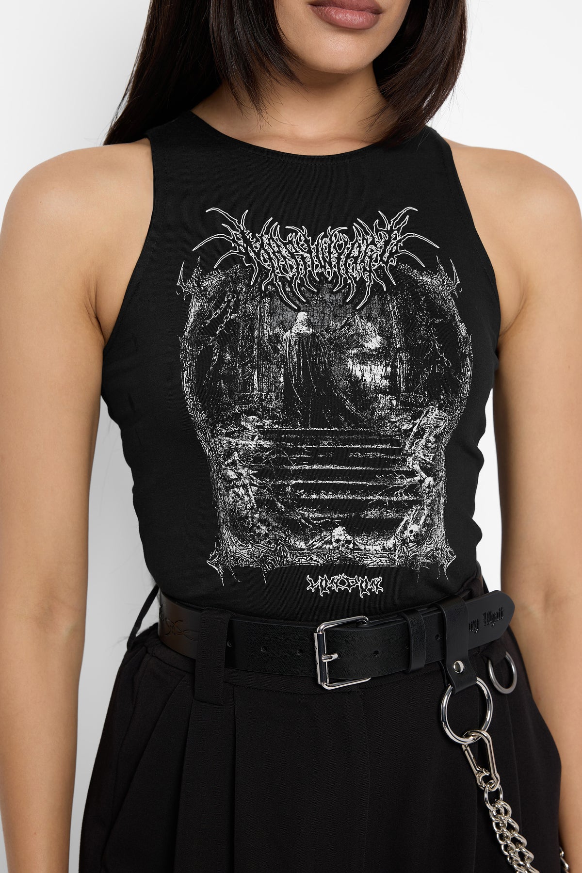 Close-up of the Keres racer vest's white graphic of a cloaked figure on a stone staircase inside an arch of trees, with spiky lettering above and small text beneath.